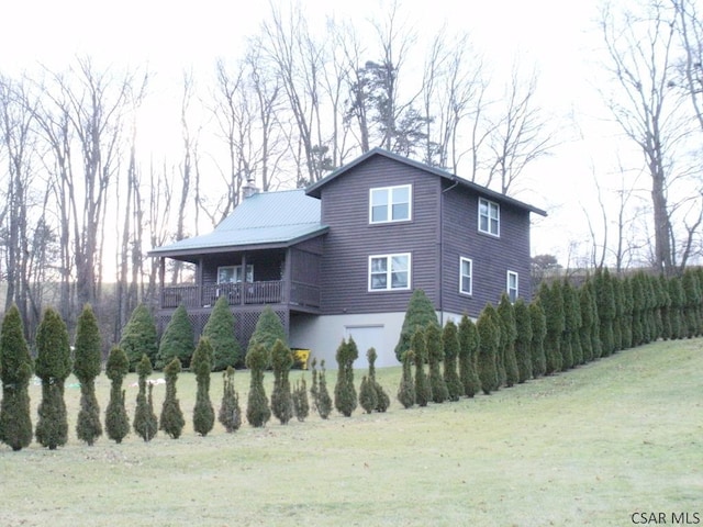 view of side of home with a lawn