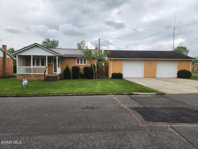 1508 Gillespie Ave, Portage, PA 15946 - ranch-style house featuring driveway, covered porch, brick siding, and a garage