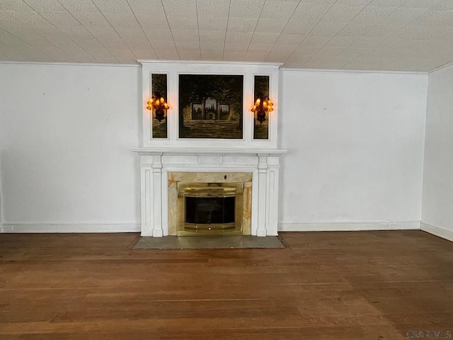 unfurnished living room with dark hardwood / wood-style flooring and a high end fireplace