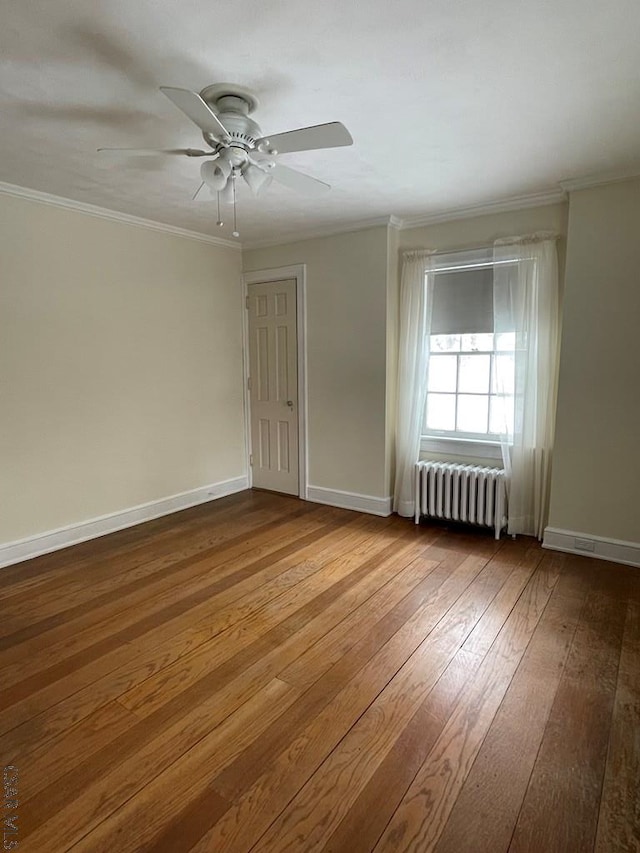 unfurnished room featuring crown molding and radiator