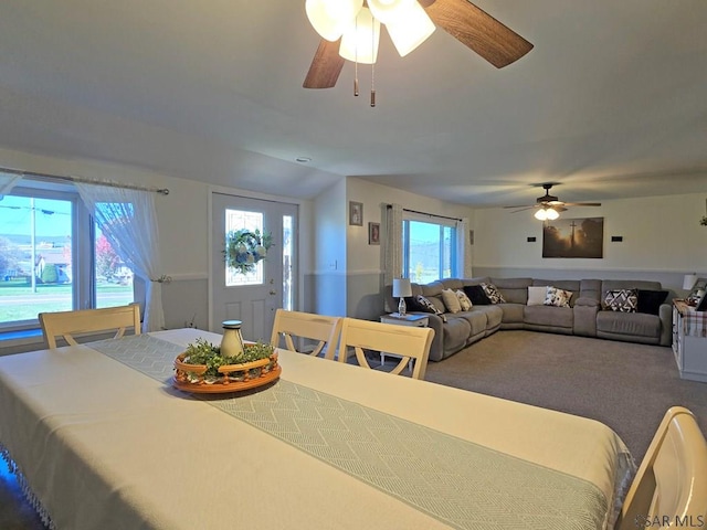 dining area featuring plenty of natural light, carpet flooring, and lofted ceiling