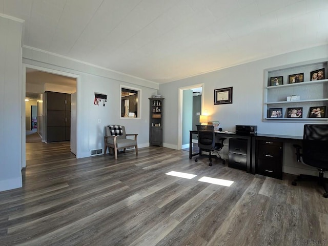 office area featuring ornamental molding, dark hardwood / wood-style floors, and built in features