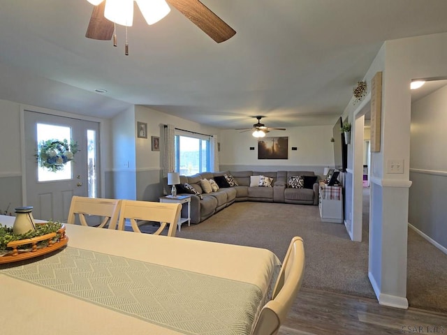 dining space with vaulted ceiling, ceiling fan, and hardwood / wood-style floors