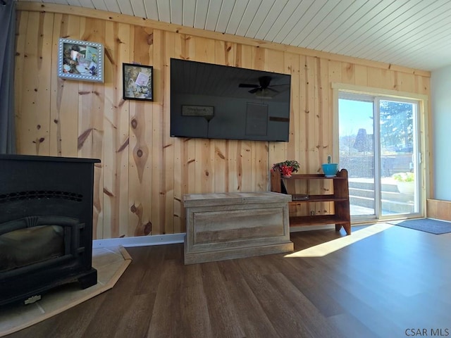 living room featuring dark hardwood / wood-style floors and wood walls