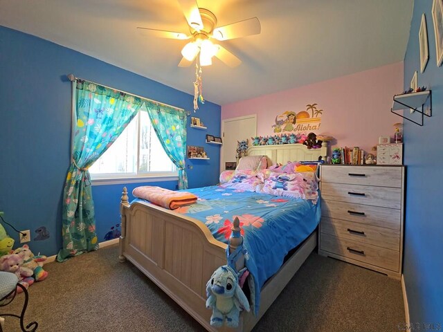 bedroom featuring ceiling fan and dark carpet