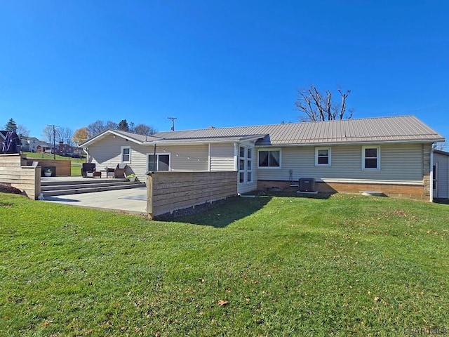 rear view of house with a yard, a patio, and central air condition unit