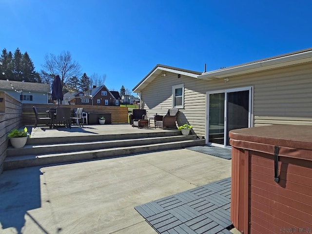 deck with a hot tub and a patio area