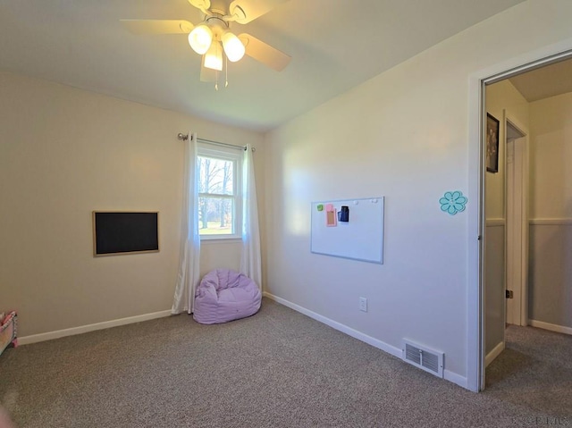 rec room with carpet and ceiling fan