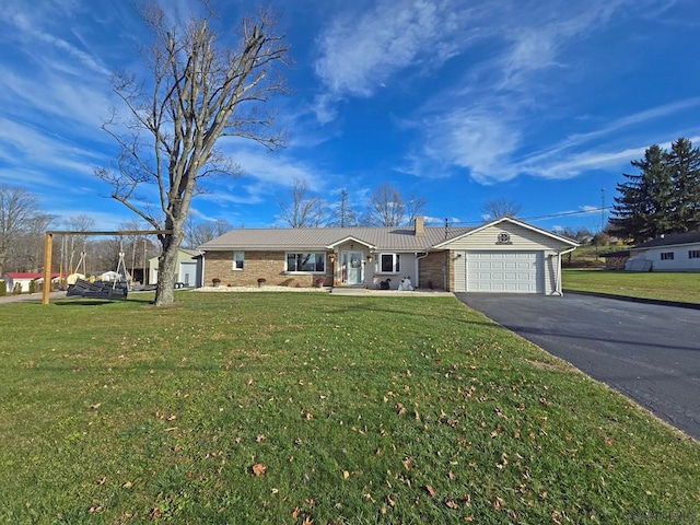 single story home featuring a garage and a front lawn