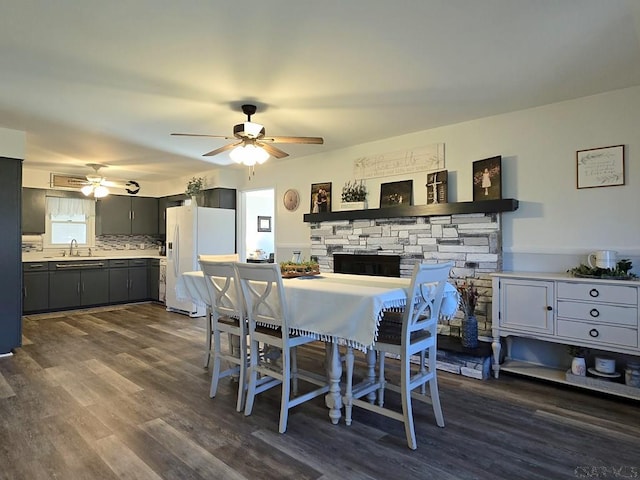 dining area with sink, dark hardwood / wood-style floors, and ceiling fan