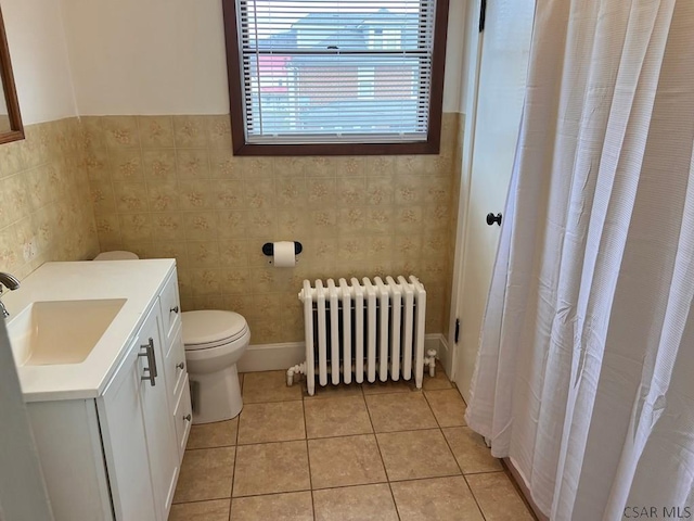 bathroom with vanity, radiator, tile patterned floors, and toilet