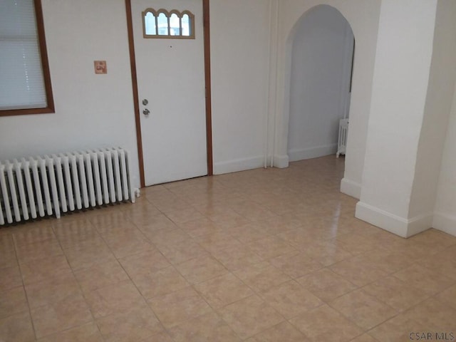 unfurnished room with radiator heating unit