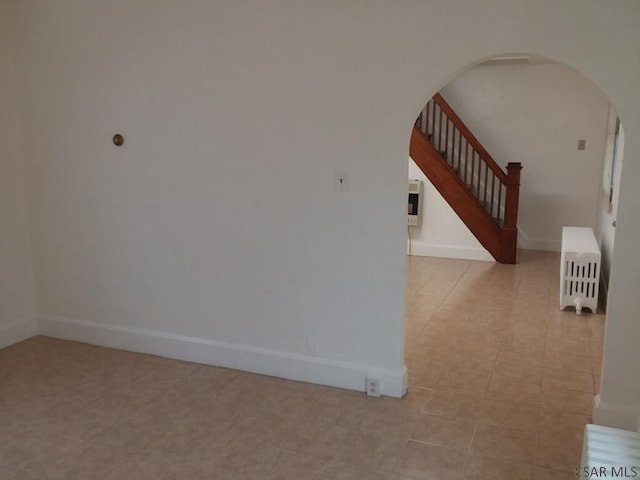 unfurnished room featuring radiator and heating unit