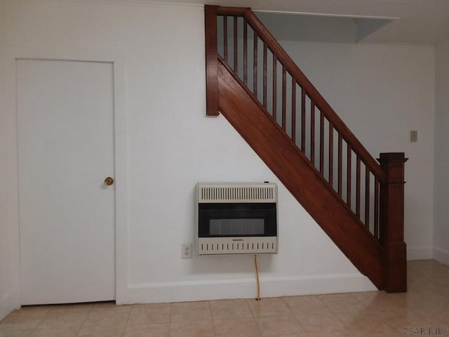 staircase featuring tile patterned flooring and heating unit