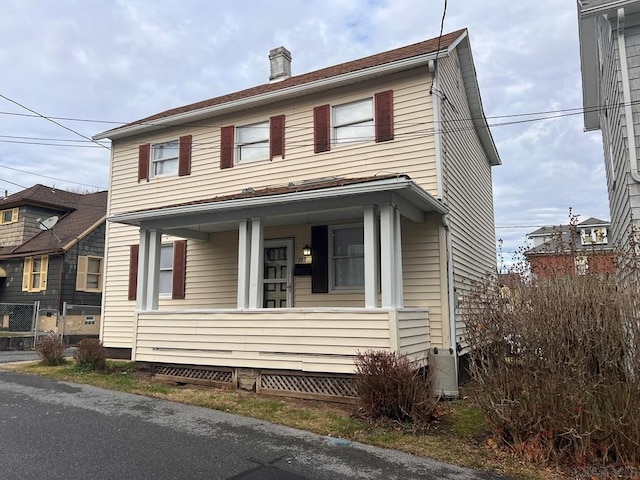 view of front facade featuring cooling unit and covered porch