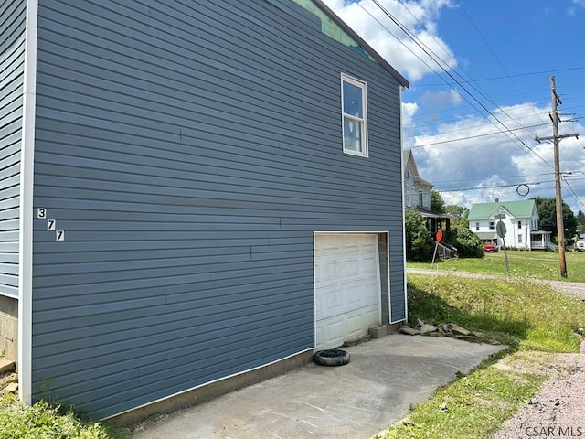 view of side of home featuring a garage