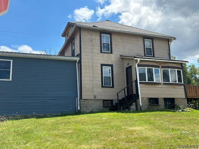 rear view of property featuring a yard