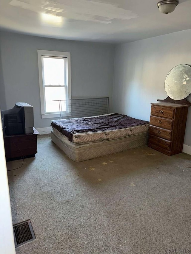 unfurnished bedroom featuring light colored carpet and visible vents