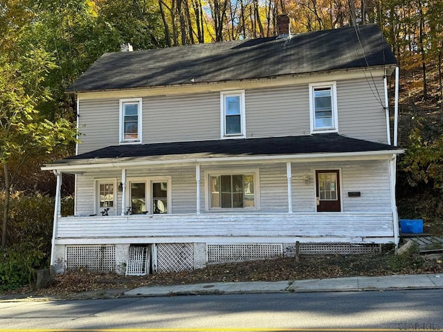 view of front of home featuring a porch and a chimney