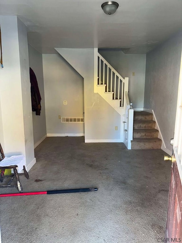 interior space with carpet flooring, visible vents, and baseboards