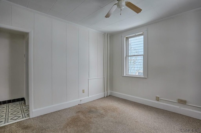 carpeted empty room with ornamental molding and ceiling fan