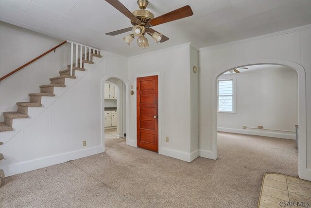 carpeted spare room with ornamental molding and ceiling fan