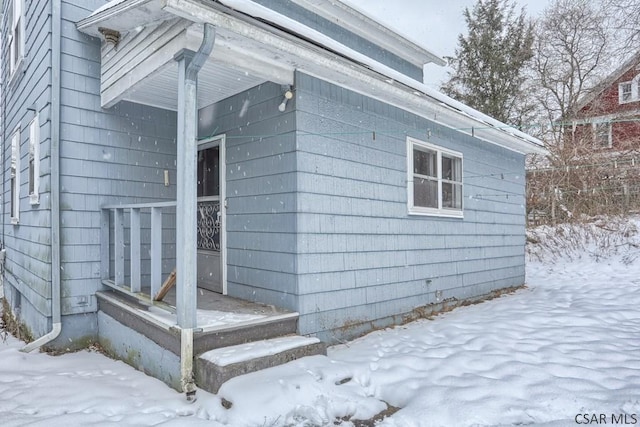 view of snow covered property entrance