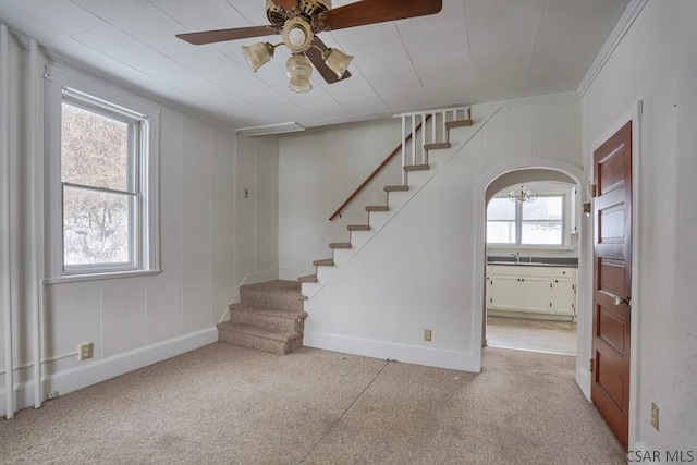 interior space with crown molding and ceiling fan