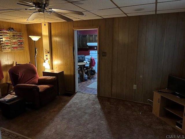 1008 Conemaugh Ave, Portage, PA 15946 - living room with ceiling fan, wood walls, carpet floors, and a drop ceiling