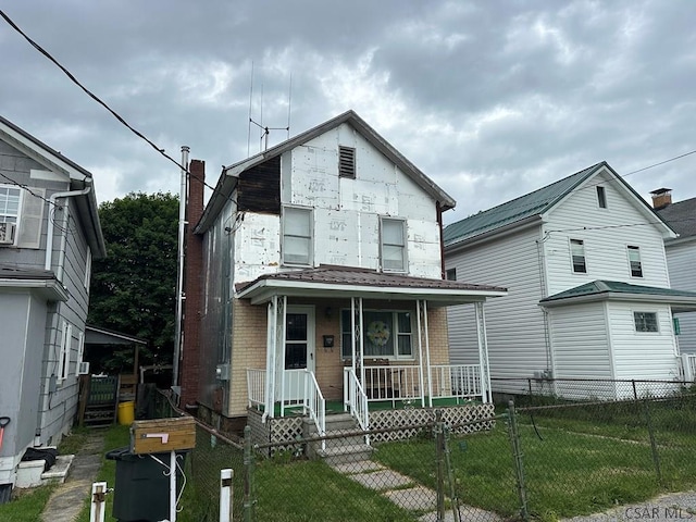 1008 Conemaugh Ave, Portage, PA 15946 - view of front of house with covered porch, a fenced front yard, a chimney, brick siding, and a gate