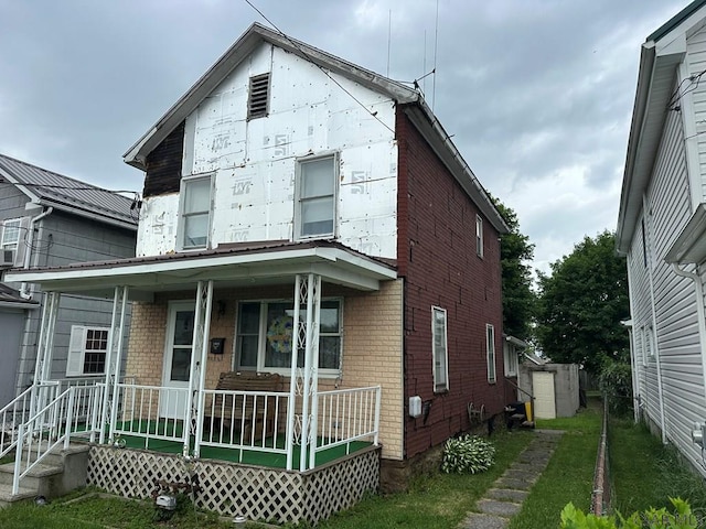 1008 Conemaugh Ave, Portage, PA 15946 - view of front facade featuring a porch and brick siding