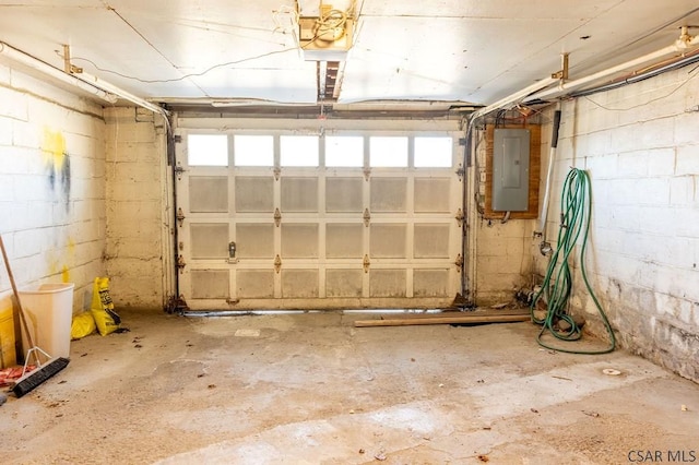 garage with concrete block wall and electric panel