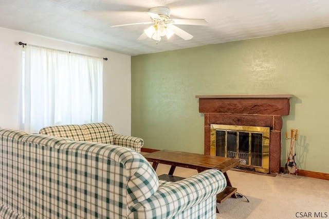 living area featuring baseboards, carpet floors, a fireplace with flush hearth, ceiling fan, and a textured wall