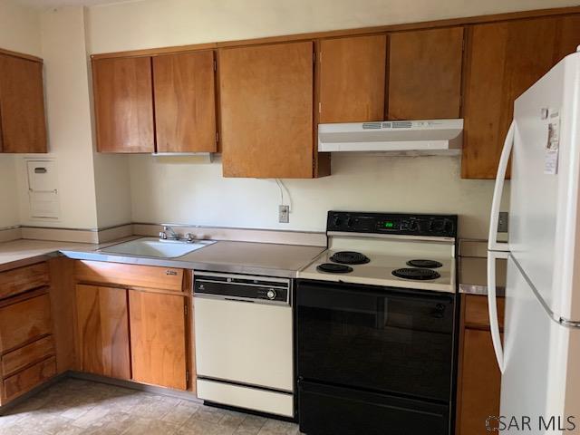 kitchen with sink and white appliances