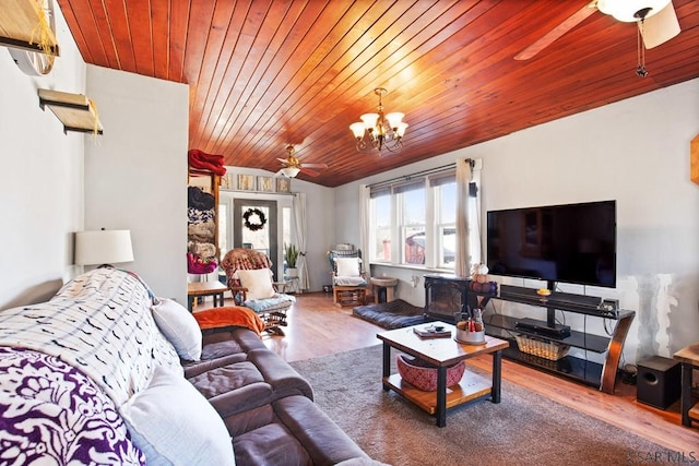 living room with wood ceiling, ceiling fan with notable chandelier, a healthy amount of sunlight, and hardwood / wood-style flooring