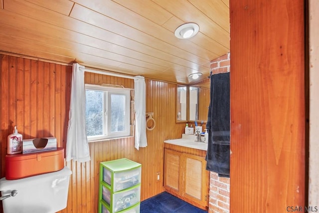 bathroom featuring lofted ceiling, wood ceiling, wooden walls, vanity, and toilet