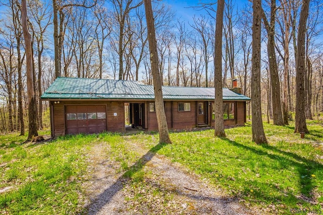 706 Laurel Summit Rd, Boswell, PA 15531 - view of front facade with dirt driveway, an attached garage, metal roof, and a chimney