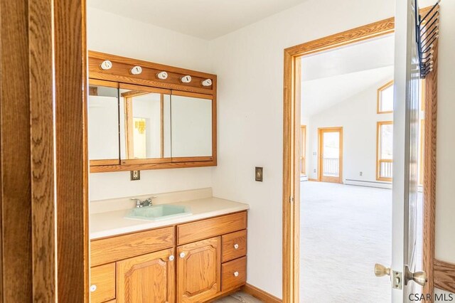 bathroom with vanity, vaulted ceiling, and baseboard heating