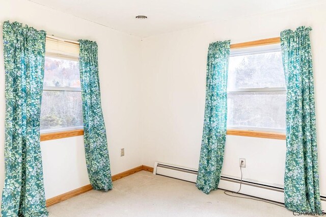 carpeted spare room with baseboard heating