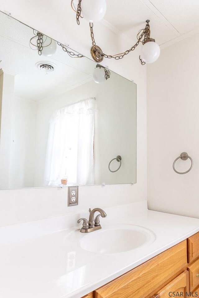 bathroom featuring vanity and crown molding