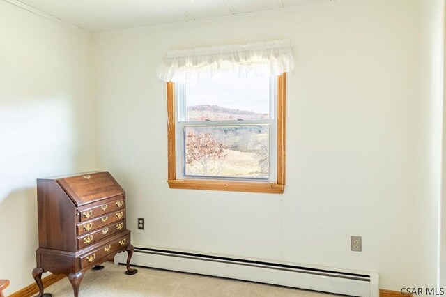 carpeted spare room with baseboard heating