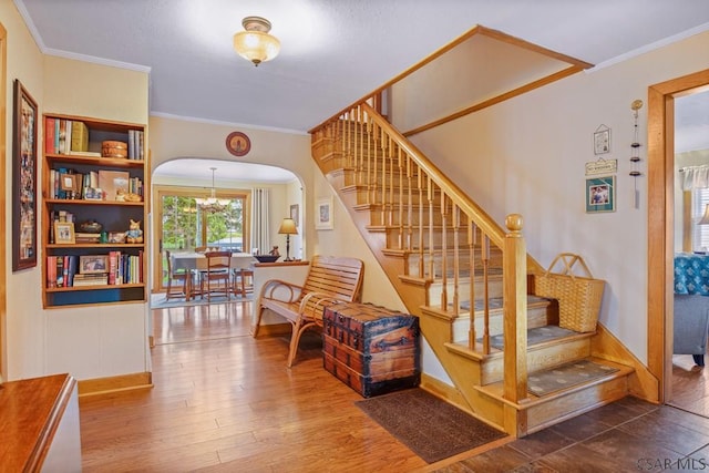 352 W Garrett St, Somerset, PA 15501 - stairway featuring arched walkways, wood finished floors, baseboards, and ornamental molding