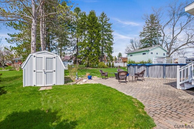 352 W Garrett St, Somerset, PA 15501 - view of yard featuring a covered pool, a storage unit, a patio area, an outbuilding, and a fire pit