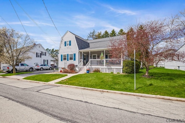 352 W Garrett St, Somerset, PA 15501 - dutch colonial featuring a gambrel roof, a front yard, covered porch, and a shingled roof