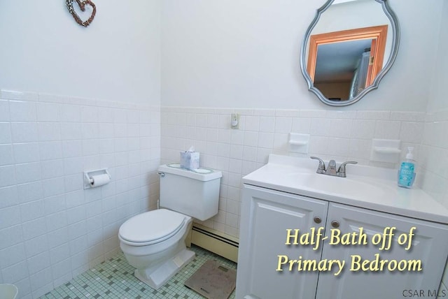 312 Furnari Ave, Johnstown, PA 15905 - bathroom with a baseboard radiator, tile walls, vanity, wainscoting, and tile patterned floors