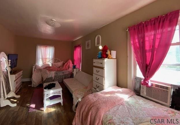 bedroom featuring cooling unit and dark hardwood / wood-style flooring