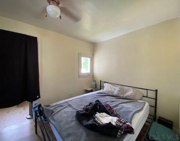 bedroom featuring hardwood / wood-style flooring and ceiling fan