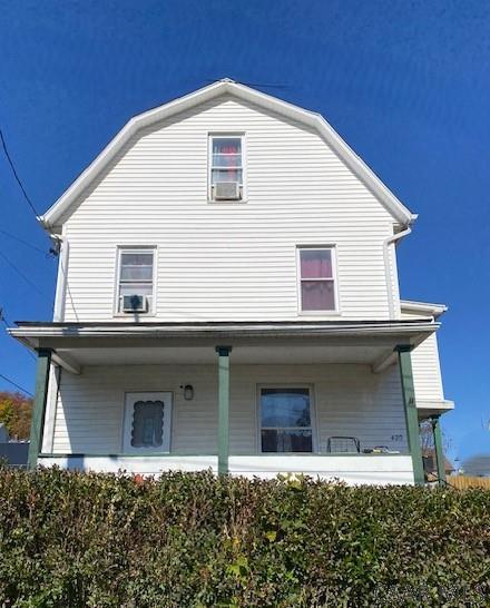 back of house featuring covered porch