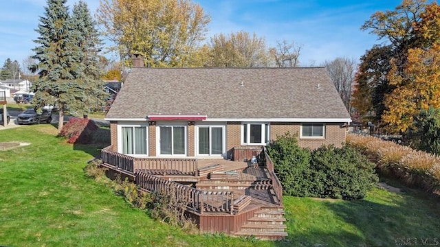 back of property featuring a yard and a deck