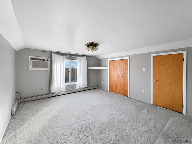 unfurnished bedroom featuring vaulted ceiling, an AC wall unit, carpet floors, and baseboard heating